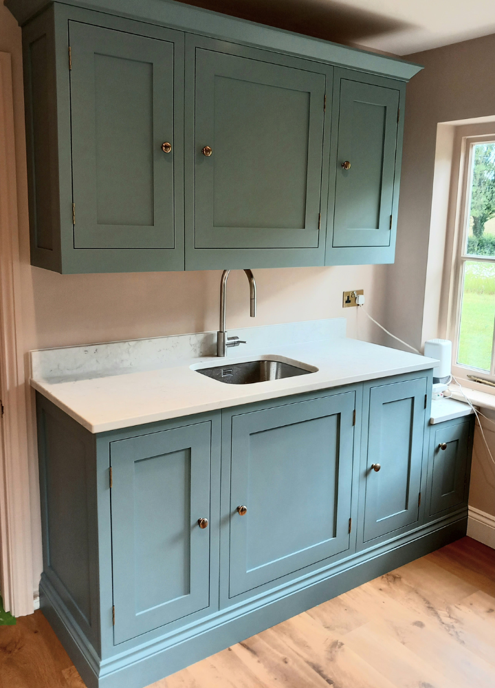 Blue-green customer utility kitchen fitted with Plain Shaker cabinet doors