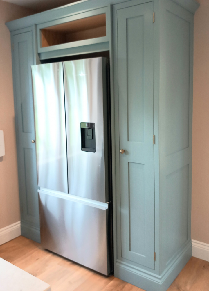 Blue-green customer kitchen cabinetry with Plain Shaker doors around an American fridge