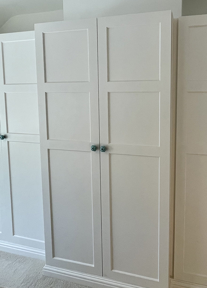 Grey fitted wardrobes with distinctive Shaker Hole and Slot door detailing