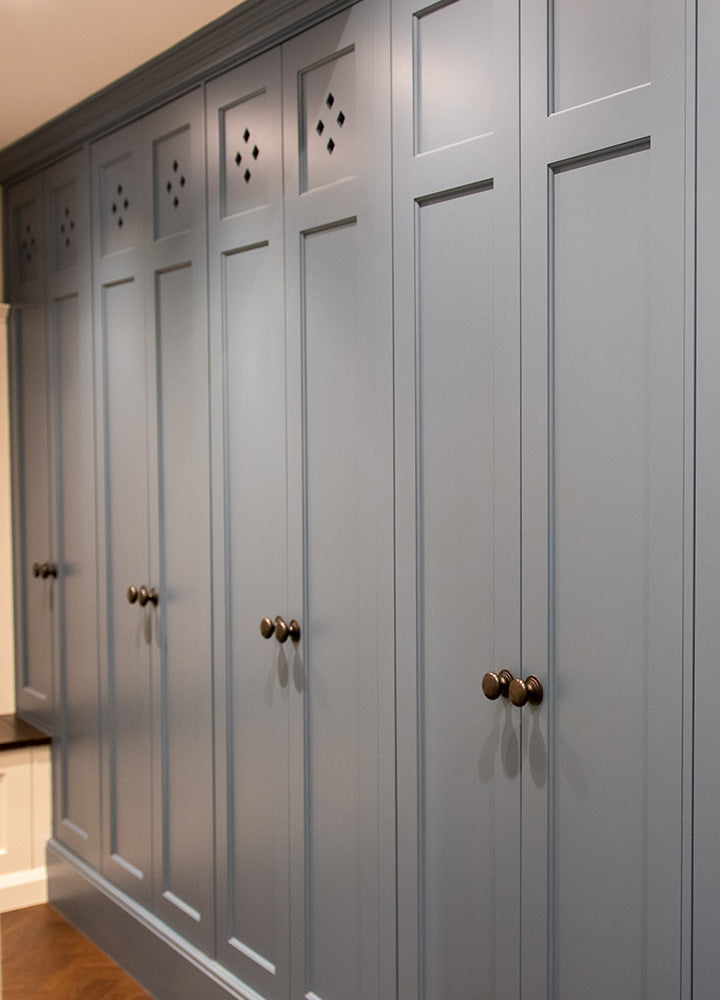 Cream fitted bedroom wardrobes with decorative moulded door panels